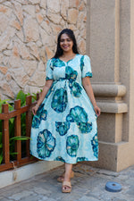 Sky Teal Bold Floral Rayon Foil Maxi Frock – Puff Sleeve Tiered Summer Dress with Adjustable Front Tie & Side Pockets