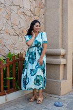 Sky Teal Bold Floral Rayon Foil Maxi Frock – Puff Sleeve Tiered Summer Dress with Adjustable Front Tie & Side Pockets