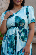 Sky Teal Bold Floral Rayon Foil Maxi Frock – Puff Sleeve Tiered Summer Dress with Adjustable Front Tie & Side Pockets